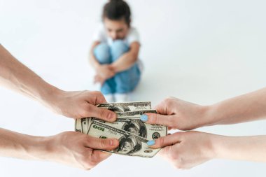 selective focus of man giving alimony to woman near african american daughter on white clipart