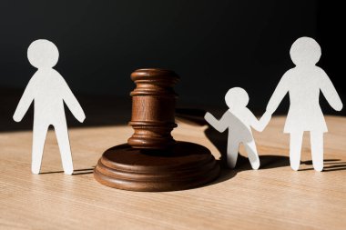 paper people near wooden gavel on black, divorce concept  clipart