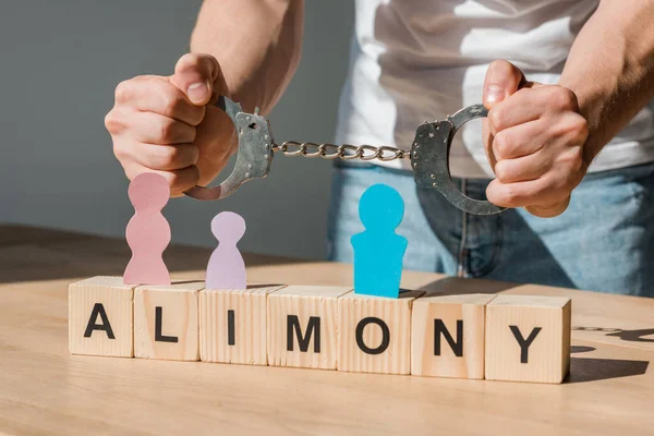 Cropped View Handcuffed Man Wooden Blocks Alimony Lettering Paper People — Stock Photo, Image