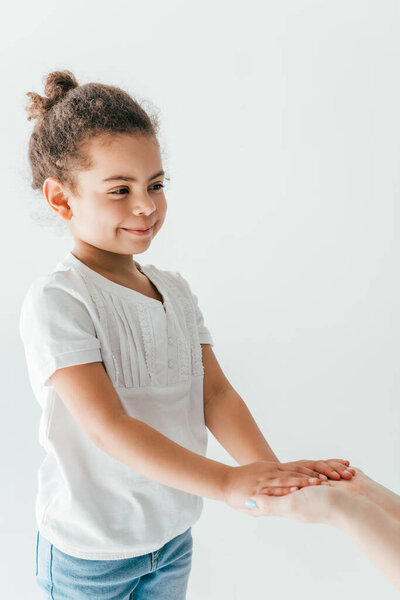 foster mother holding hands with happy and adopted african american kid isolated on white 