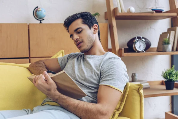 Mann Liest Buch Und Liegt Auf Sofa Wohnzimmer — Stockfoto