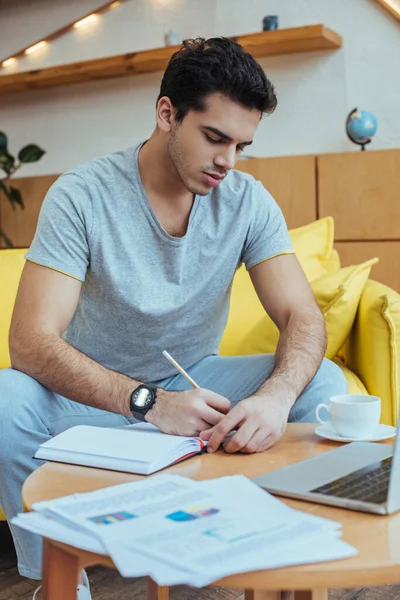 Selective Focus Freelancer Writing Notebook Coffee Table Sofa — Stock Photo, Image