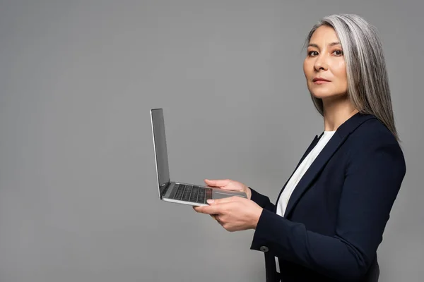 Attractive Serious Asian Businesswoman Grey Hair Using Laptop Isolated Grey — Stock Photo, Image