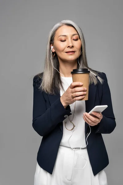 Beautiful Asian Businesswoman Coffee Listening Music Earphones Smartphone Isolated Grey — Stock Photo, Image