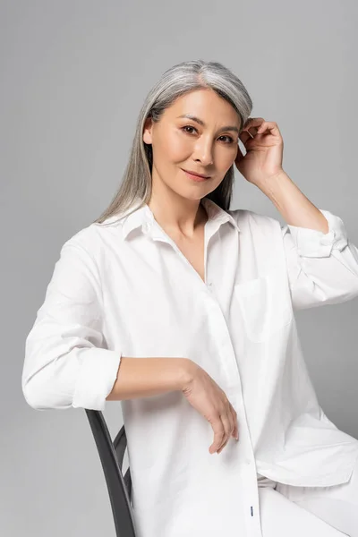 Beautiful Pensive Asian Woman Grey Hair Sitting Chair Isolated Grey — Stock Photo, Image
