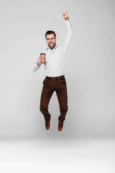 Excited Businessman Holding Paper Cup While Levitating Grey — Stock Photo, Image