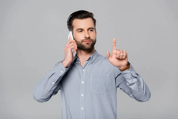 Bearded Businessman Pointing Finger Talking Smartphone Isolated Grey — Stock Photo, Image