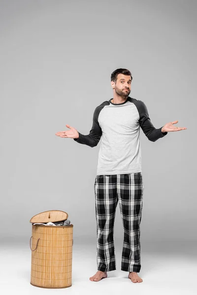 Bearded Man Showing Shrug Gesture While Standing Laundry Basket Grey — Stock Photo, Image