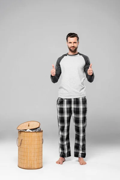 Happy Man Showing Thumbs While Standing Laundry Basket Grey — Stock Photo, Image