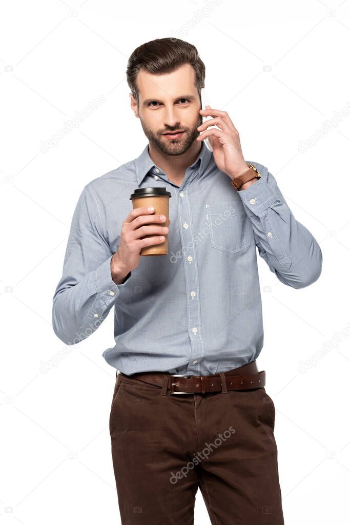 handsome man holding coffee to go and talking on smartphone isolated on white 