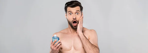 Panoramic Shot Surprised Man Touching Face Holding Bottle Blue Shave — Stock Photo, Image