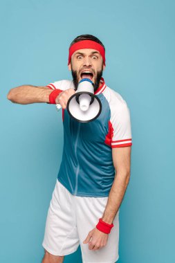 emotional stylish sportsman with loudspeaker on blue background clipart