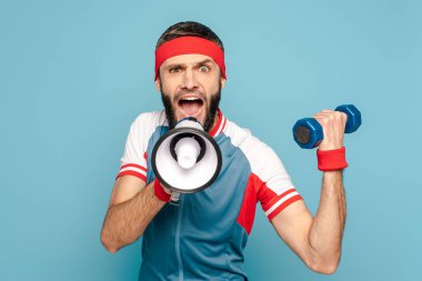 emotional stylish sportsman yelling in loudspeaker and holding dumbbell on blue background clipart
