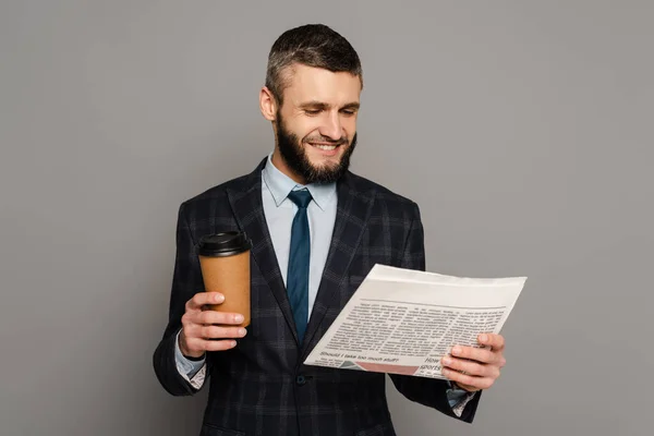 Улыбающийся Красивый Бородатый Бизнесмен Костюме Кофе Идет Читать Газету Сером — стоковое фото