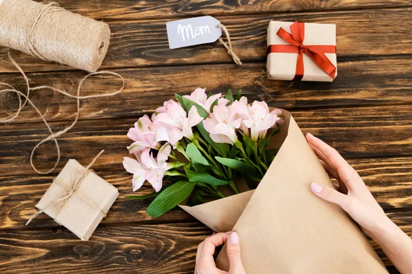 Cropped View Woman Wrapping Pink Flowers Paper Gift Boxes Wooden — Stock Photo, Image