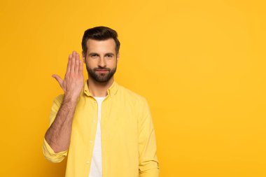 Man showing sign in deaf and dumb language on yellow background