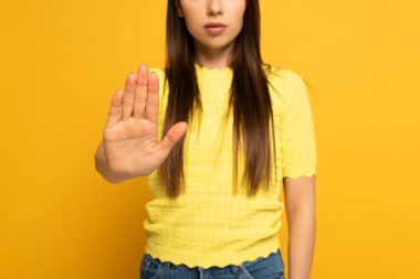 Cropped view of woman showing no sign on yellow background clipart