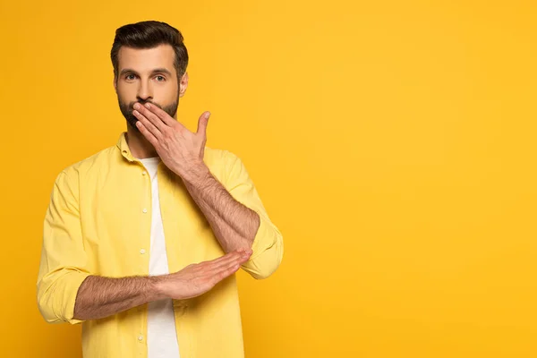 Handsome Man Covering Mouth While Using Sign Language Yellow Background — Stock Photo, Image