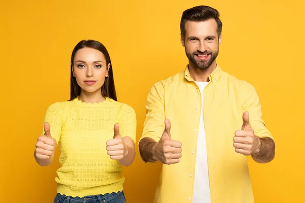 Young Couple Showing Tums Camera Yellow Background — Stock Photo, Image