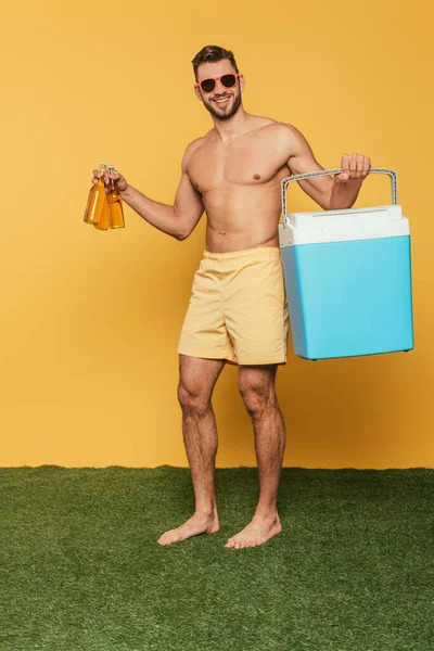 Cheerful Shirtless Man Holding Portable Fridge Bottles Beer Yellow Background — Stock Photo, Image