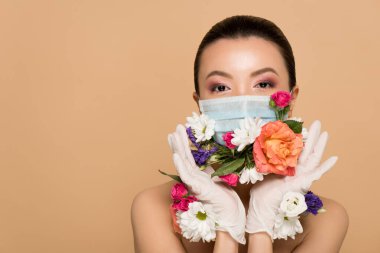 beautiful nude asian girl in latex gloves and floral face mask isolated on beige clipart