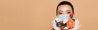 panoramic shot of asian girl in latex gloves and floral face mask isolated on beige clipart