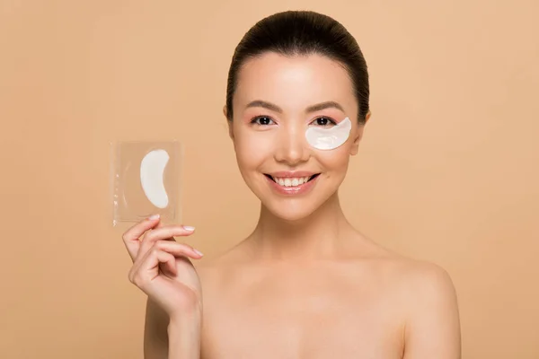 Attractive Cheerful Nude Asian Woman Collagen Eye Pads Isolated Beige — Stock Photo, Image