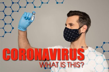 Güvenlik maskeli adam aşı kavanozunu gri, koronavirüs üzerinde izole etti. Bu resimde ne var? 