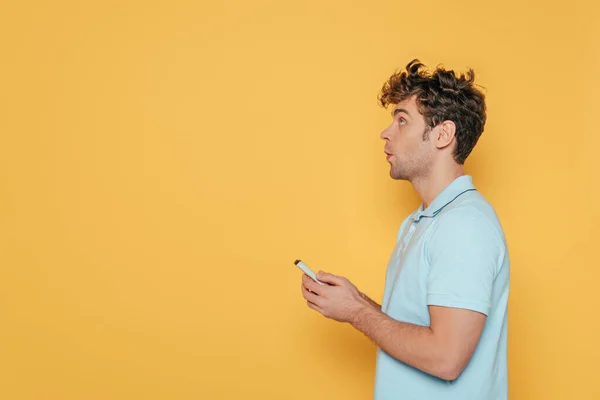 Side View Man Holding Remote Controller Isolated Yellow — Stock Photo, Image