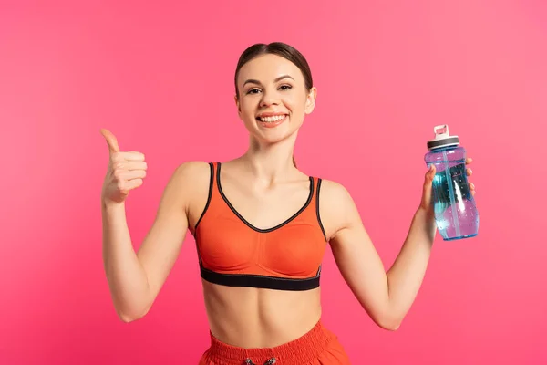 Happy Sportswoman Showing Thumb Holding Sports Bottle Water Isolated Pink — Stock Photo, Image