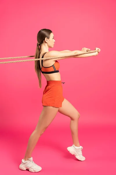 Young Sportswoman Pulling Rope While Exercising Pink — Stock Photo, Image