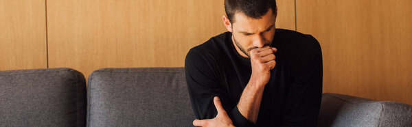 horizontal crop of sick man coughing at home 