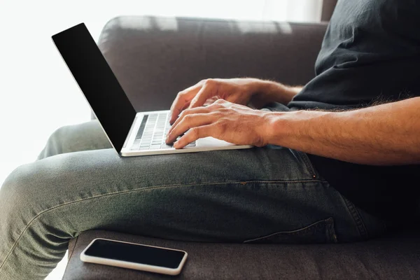 Cropped View Freelancer Typing Laptop Keyboard Smartphone Blank Screen Sofa — Stock Photo, Image