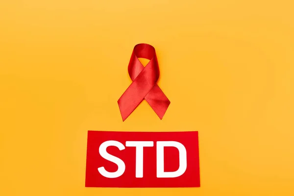 Top View Red Ribbon Hiv Awareness Std Lettering Isolated Orange — Stock Photo, Image