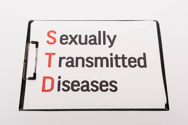 top view of clipboard with sexually transmitted diseases lettering isolated on white