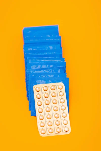 Top View Contraceptive Pills Packs Condoms Isolated Orange — Stock Photo, Image