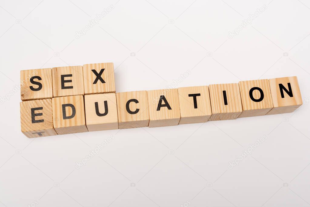 top view of wooden cubes with sex education lettering isolated on white 