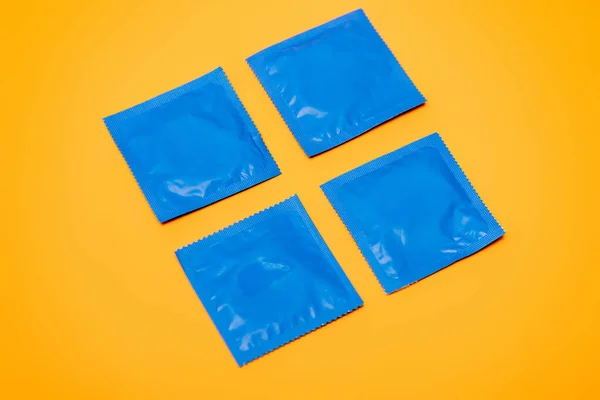 Blaue Packungen Mit Verhütungskondomen Isoliert Auf Orange — Stockfoto