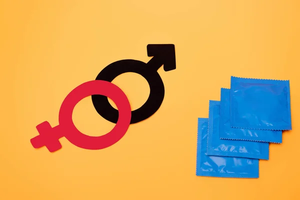 Top View Gender Symbols Condoms Isolated Orange — Stock Photo, Image