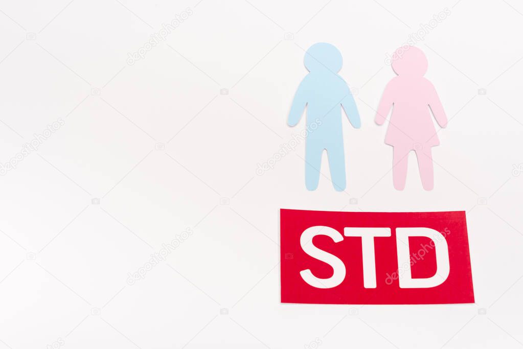 top view of paper people near std lettering isolated on white