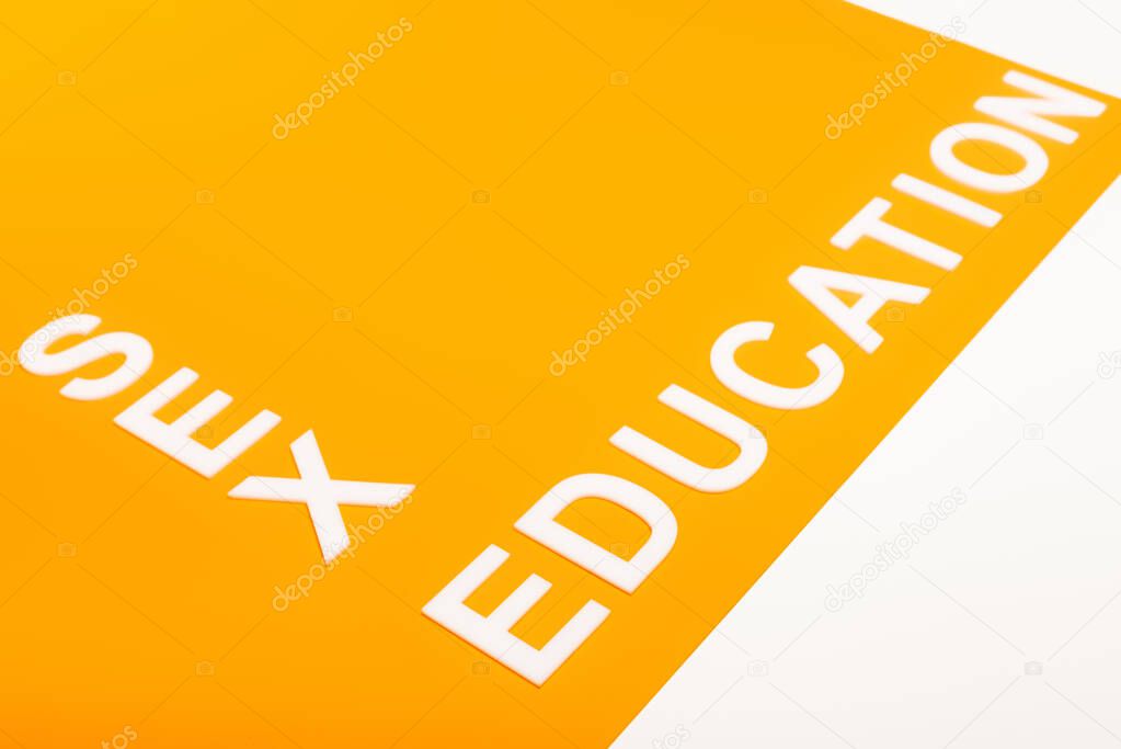 sex education lettering on orange surface isolated on white 