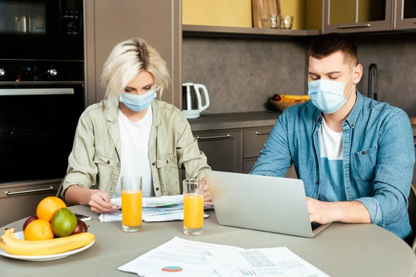 Couple Medical Masks Working Papers Laptop Orange Juice Gasses Kitchen — Stock Photo, Image