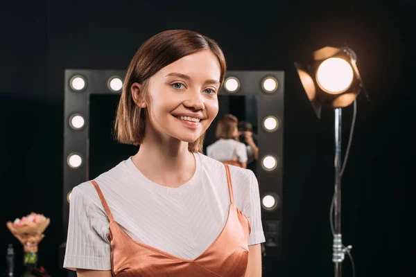 Beautiful woman smiling at camera in photo studio