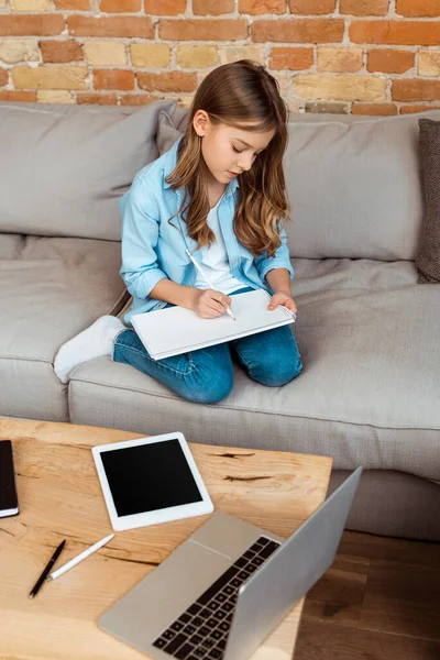 Happy Kid Sitting Sofa Writing Notebook Gadgets — Stock Photo, Image
