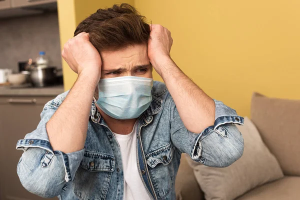 Stressed Man Medical Mask Hands Head Sitting Couch Home — Stock Photo, Image