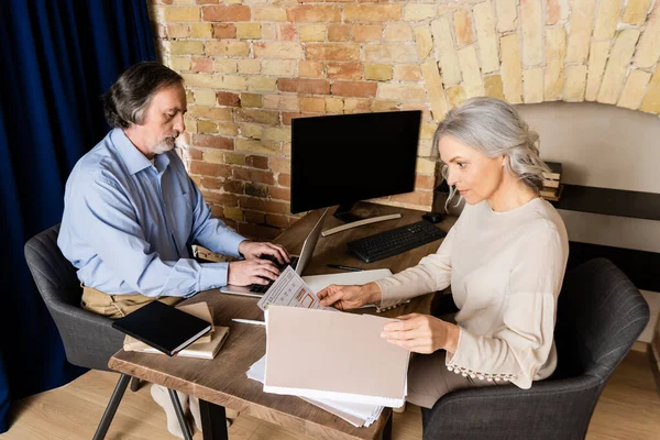 Mature Man Typing Laptop Wife Looking Document — Stock Photo, Image
