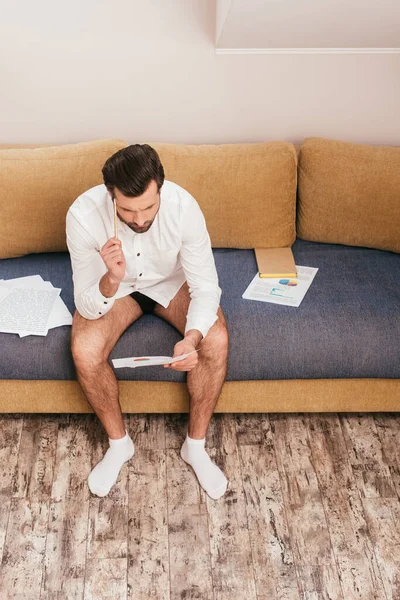 Pensive Freelancer Shirt Panties Looking Documents Book Sofa Living Room — Stock Photo, Image