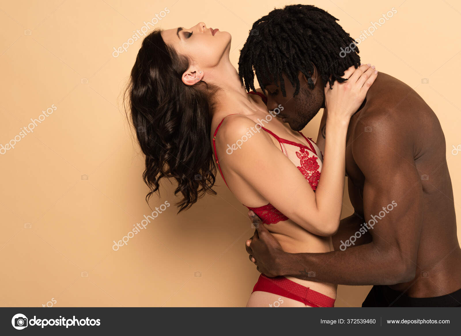 Handsome African American Man Hugging Kissing Breast Sexy Woman Beige Stock Photo by ©IgorVetushko 372539460 pic