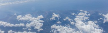 Aerial view of clouds above sea and Catalonia, Spain, panoramic shot  clipart