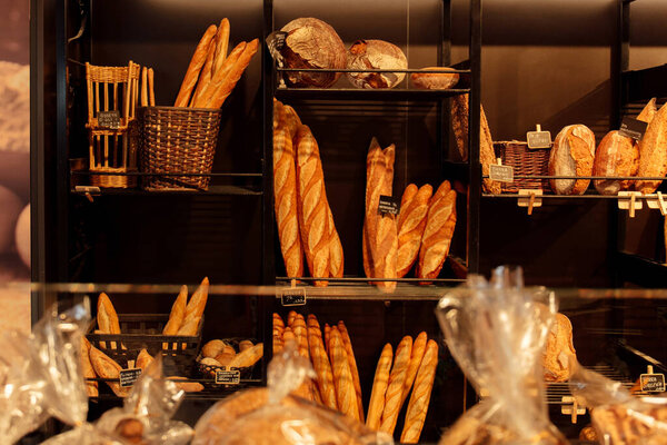 Selective focus of baguettes and bread on bakery showcase in Catalonia, Spain 